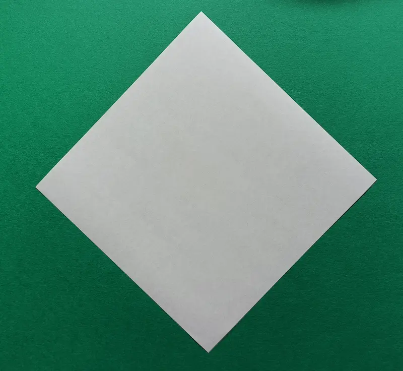 Place your square paper like a diamond shape on the table.