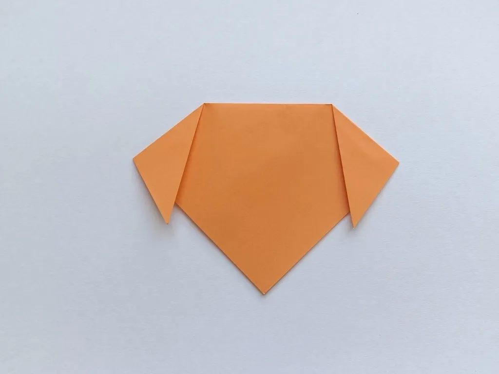 Fold the right corner down to make the other ear.