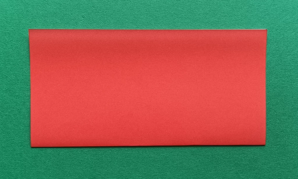 Fold the paper in half by matching the bottom corner to the top