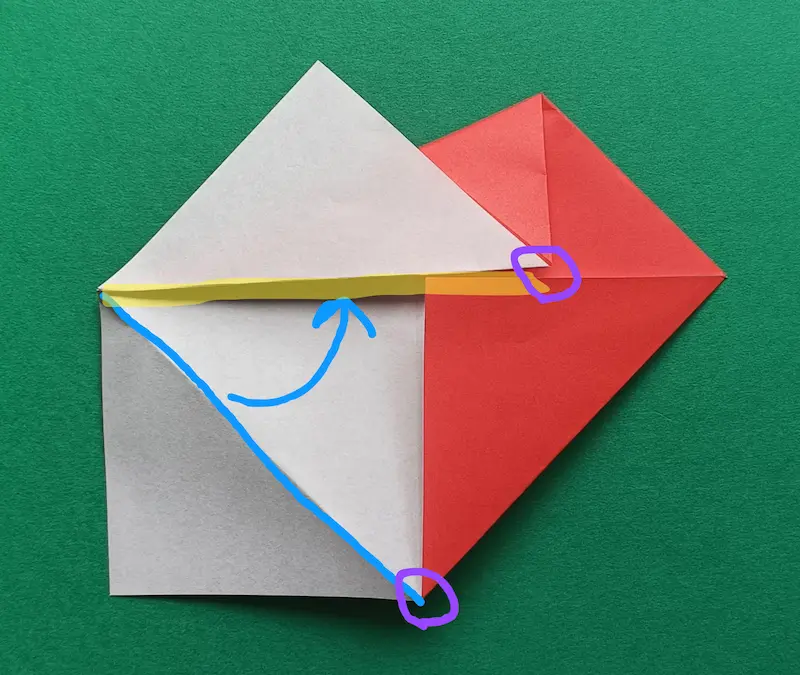 Fold the blue line to meet the yellow line. It’s perfect if the corners in the purple circle line up!