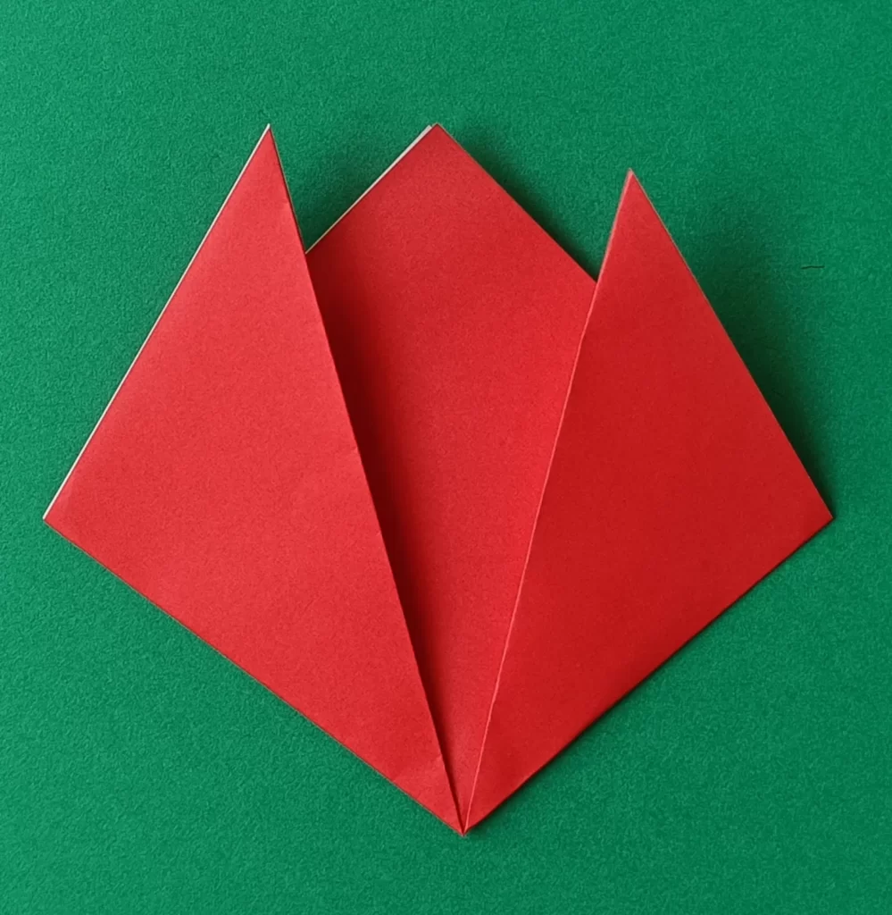 Fold the right corner up to make the other one