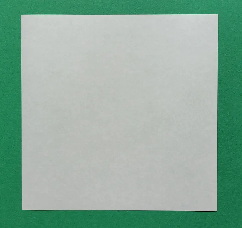 Place the square paper flat on the table