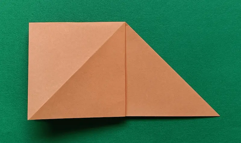 Put your finger in the top triangle, open it up, and flatten it