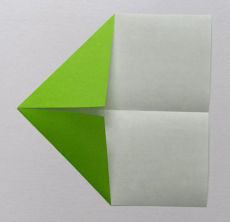 Fold the top-left corner to meet the crease.