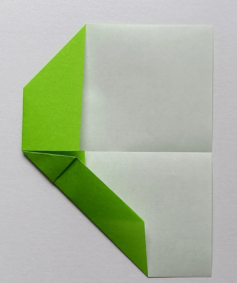 As you see in the photo, fold both the top and bottom edges to meet the center crease (bottom side)