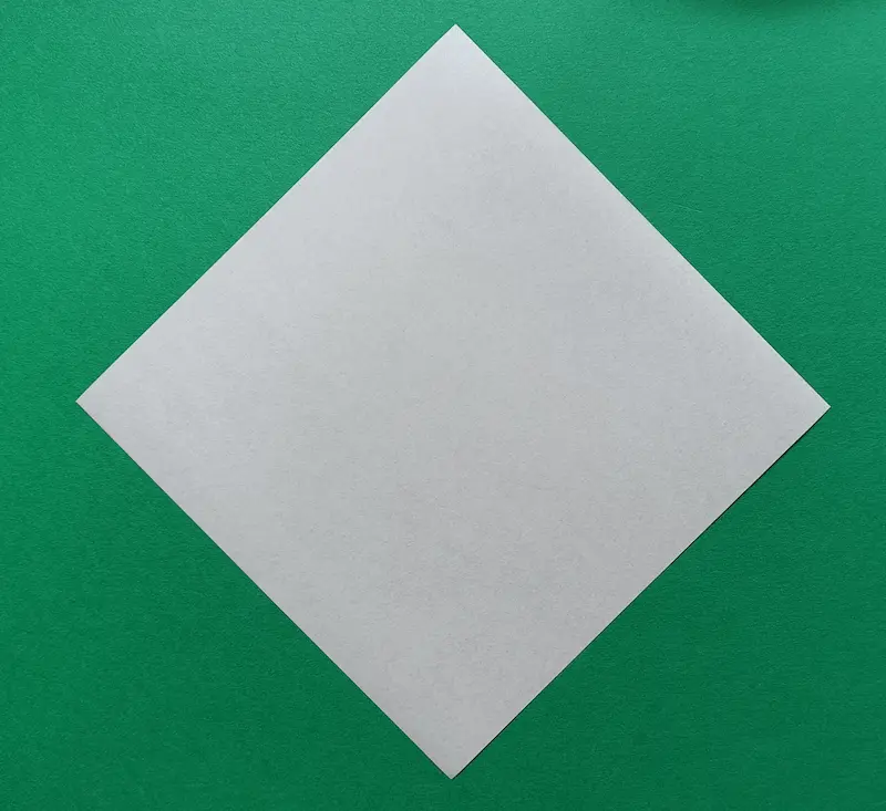 Place your paper on the table like a diamond shape