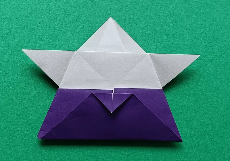 Fold the top corner of the triangle down a little bit