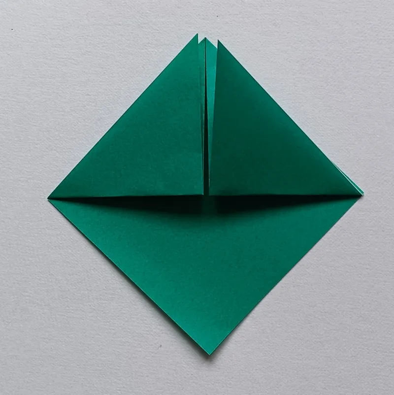 Fold the bottom right flap up to the top corner