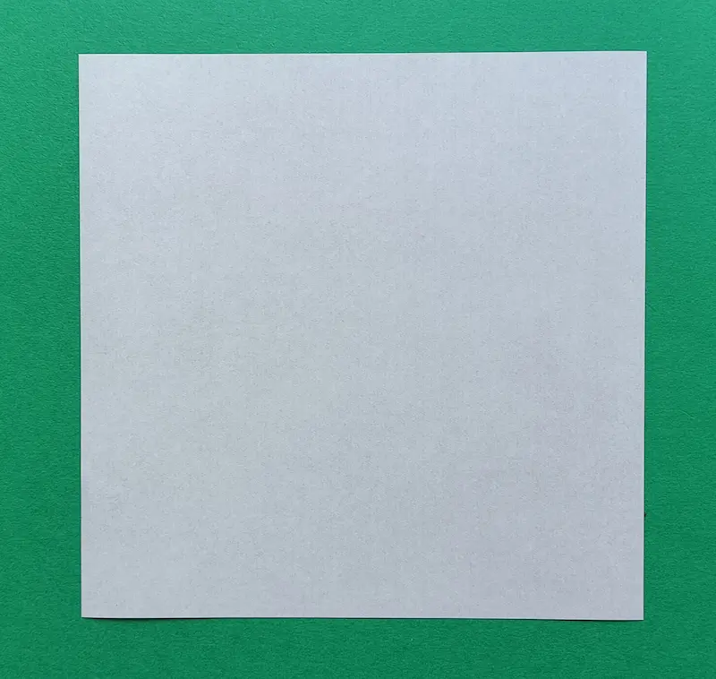 Place the square paper flat on the table