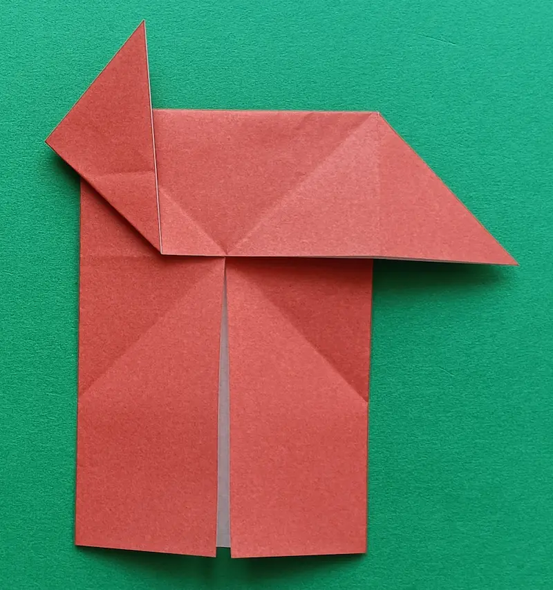 Take the left corner and fold it upwards