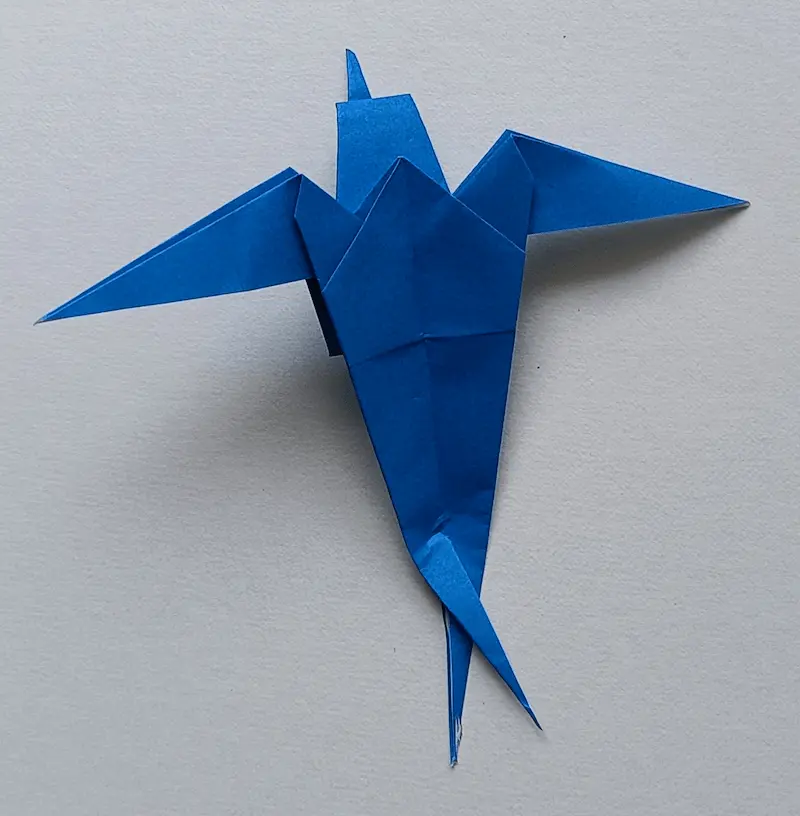Cut the bottom corner with scissors and cross the parts