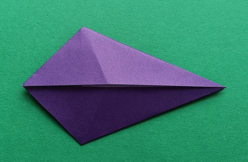 Put your finger in the top pocket, and fold it to meet the center crease