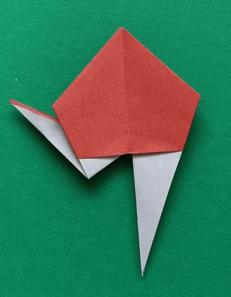Make an inside reverse fold at bottom left corner